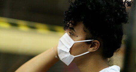 Commuter black girl in underground subway wearing face mask