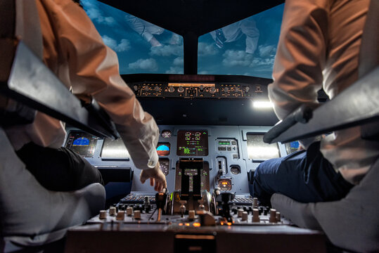 pilots in a cockpit in an airplane