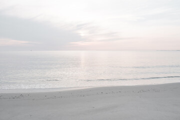 Beach scene with glistening calm ocean, beautiful sky and perfect sandy beaches - light with lots of empty blank copy space - good for backgrounds and banners