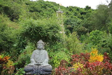Buddha statue in Thanh Dia My Son with green trees in nature in Vietnam