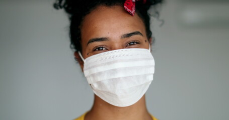 African american woman putting covid-19 face mask prevention against disease