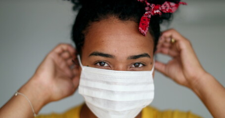 African american woman putting covid-19 face mask prevention against disease