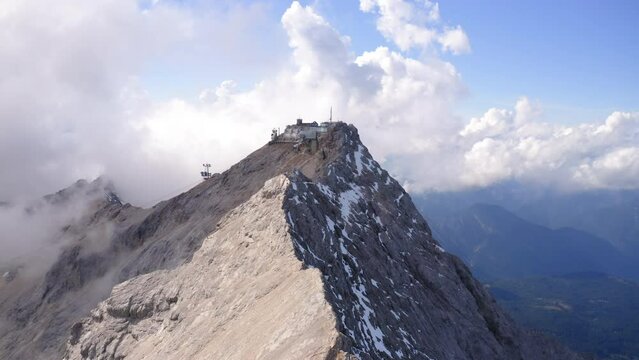 Aerial Upward Shot Of Cable Car Station On Mountain Peak During Cold Temperature - Garmisch-Partenkirchen, Germany