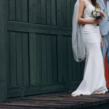 a bridal couple in love on a wedding day, blue suite and white slim dress