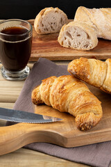 Breakfast with salty croissant, bread and coffee.
