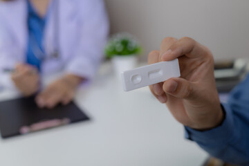 Close-up of a patient holding an ATK.