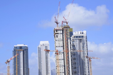 Modern high-rise residential buildings. Ideal new buildings. Construction cranes.