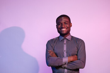 portrait of young african man with arms crossed smiling