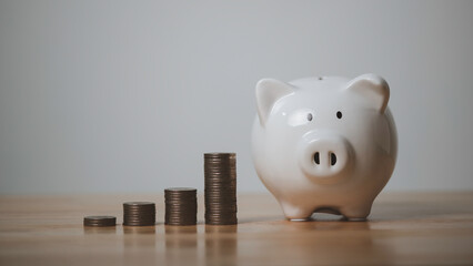 Money coin stack growing graph with piggy bank saving concept.