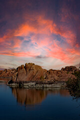 Watson Lake in Prescott Arizona with dramatic colored sky over lake and red mountains