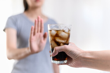 Dieting or good health concept. Young woman rejecting Junk food or unhealthy food such as sweet...