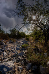White Tank Mountains in Arizona steep hiking path under dark cloudy thunder clouds