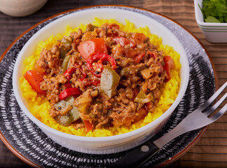 Beef curry in a bowl, with turmeric rice.