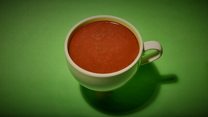 Large cup of hot chocolate, on a green background.