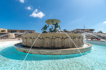 Famous fountain with three sculptures holding a disc on suburbs of Valletta.