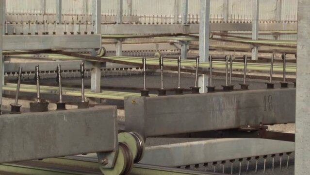 Close up shot of a machine working in waste water plant removing heavy solids, gridding, dirt, removal of sand and deodorizing while cleaning water in a room.