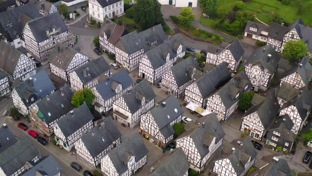 Aerial Shot Of Free-Standing Residential Buildings In Town, Drone Flying Forward Towards Church - Freudenberg, Germany