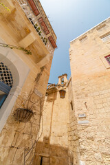 Old fortress buildings with a clear sky above in old Malta Capital Mdina