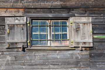 Fototapeta na wymiar wooden facade of old boathouse with window