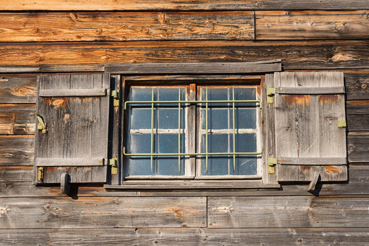 wooden facade of old boathouse with window