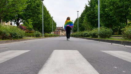 Bisexual, lesbian, female, transgender walk with LGBT flag on the road on a day and celebrate Bisexuality Day or National Coming Out Day