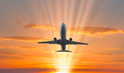 Naklejka na ściany i meble Airplane flying over tropical sea at sunset