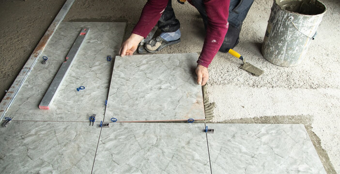 Laying floor ceramic tile. Renovating the floor