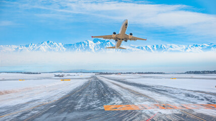 Commercical white airplane fly up over take-off runway the (ice) snow-covered airport