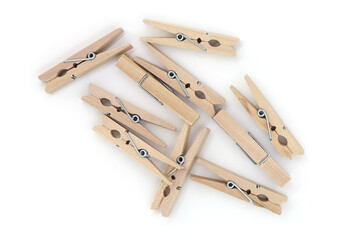 A scattering of wooden clothespins, top view. On a white background