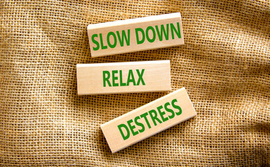 Destress symbol. Concept words Slow down Relax Destress on wooden blocks. Beautiful canvas table canvas background. Psychological business slow down Relax destress concept. Copy space.
