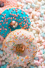 appetizing donuts with marshmallow background