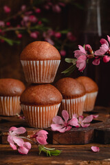 Fresh delicious chocolate muffins on a dark wooden table.