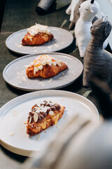 Croissant with jam, croissant with chocolate, croissant with vanilla cream on a plate. Delicious breakfast and dessert.