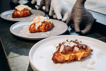 Croissant with jam, croissant with chocolate, croissant with vanilla cream on a plate. Delicious breakfast and dessert.