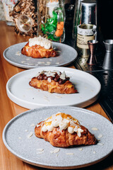 Croissant with jam, croissant with chocolate, croissant with vanilla cream on a plate. Delicious breakfast and dessert.