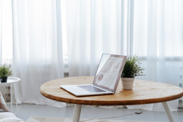 open laptop on the table in the cozy living room.