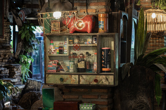 Bangkok,Thai, May 01,2022 : Vintage Medicine Bottles And Antique Collectibles Sitting On A Store Shelf In Cabinet For Old Wooden Storage Of Medicine To Decorate The Interior Of Country-style House.