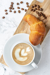 Morning coffee with croissant. Light breakfast. The atmosphere of an early calm morning.