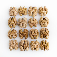 Square of peeled walnuts flat layed on white background. Copy space. Top view.