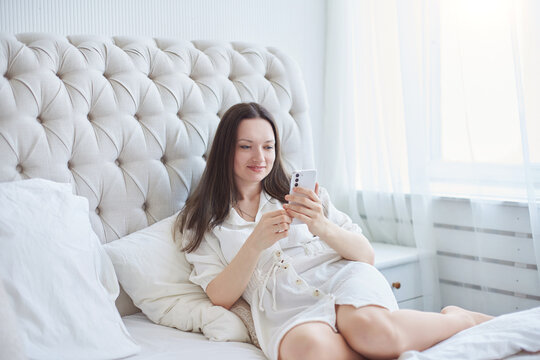 happy woman reading correspondence on her smartphone.