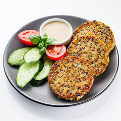 Quinoa cutlet with vegetables on a white background