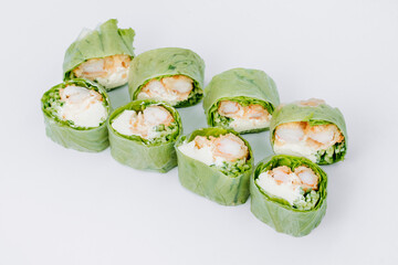 sushi rolls in lettuce with tuna salmon and cheese on a white background. restaurant menu.