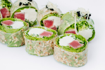 sushi rolls in lettuce with tuna salmon and cheese on a white background. restaurant menu.