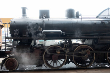 Fototapeta na wymiar Old Italian steam locomotive,park on the platform. Siena, Italy