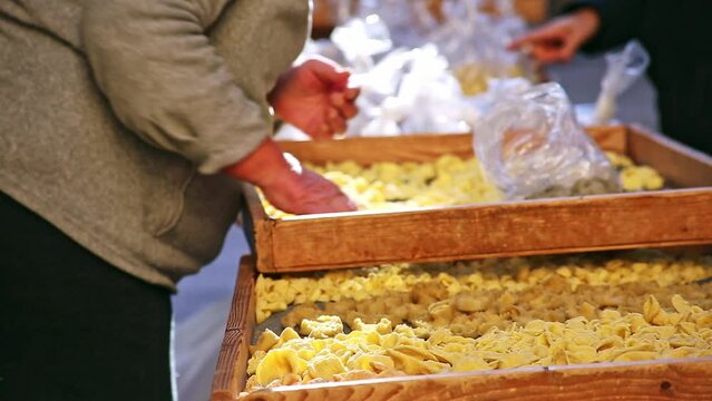 Miscellaneous b-roll cutaway shot of lady selling pasta at Italian market