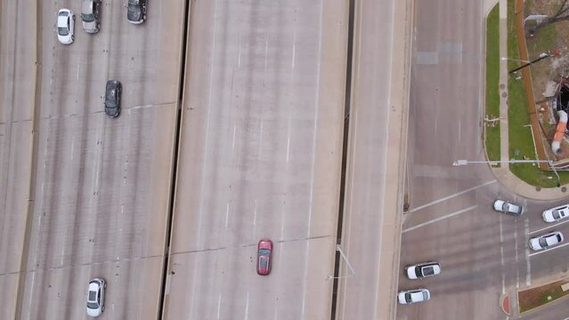 Aerial view above traffic on a interstate, in Texas, USA - rotating, birds eye, drone shot