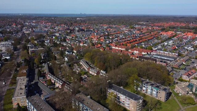 drone flight over bussum in the netherlands shows the rows of houses and buildings with the same typical architecture, neatly built in a certain order