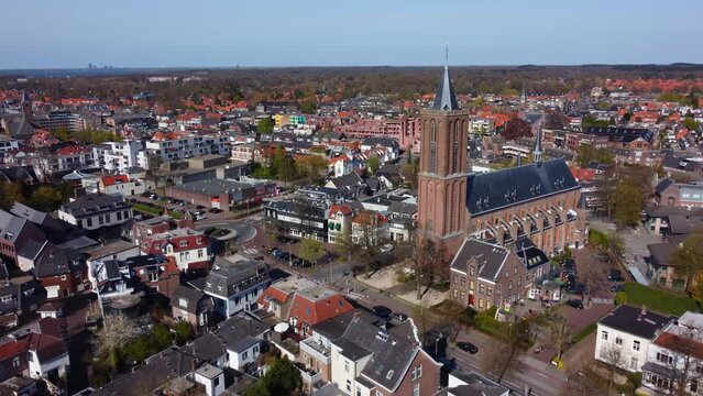 flight with the drone over the city of bussum towards the wilhelminakerk in holland in wide angle image