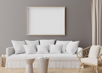 Empty horizontal picture frame on grey wall in modern living room. Mock up interior in scandinavian, boho style. Free, copy space for your picture, poster. Rattan armchair, sofa. 3D rendering.