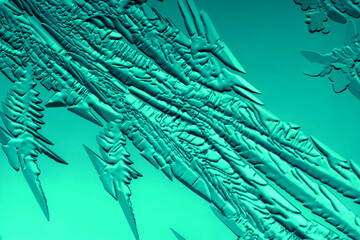 Drawings of ice on blue glass.